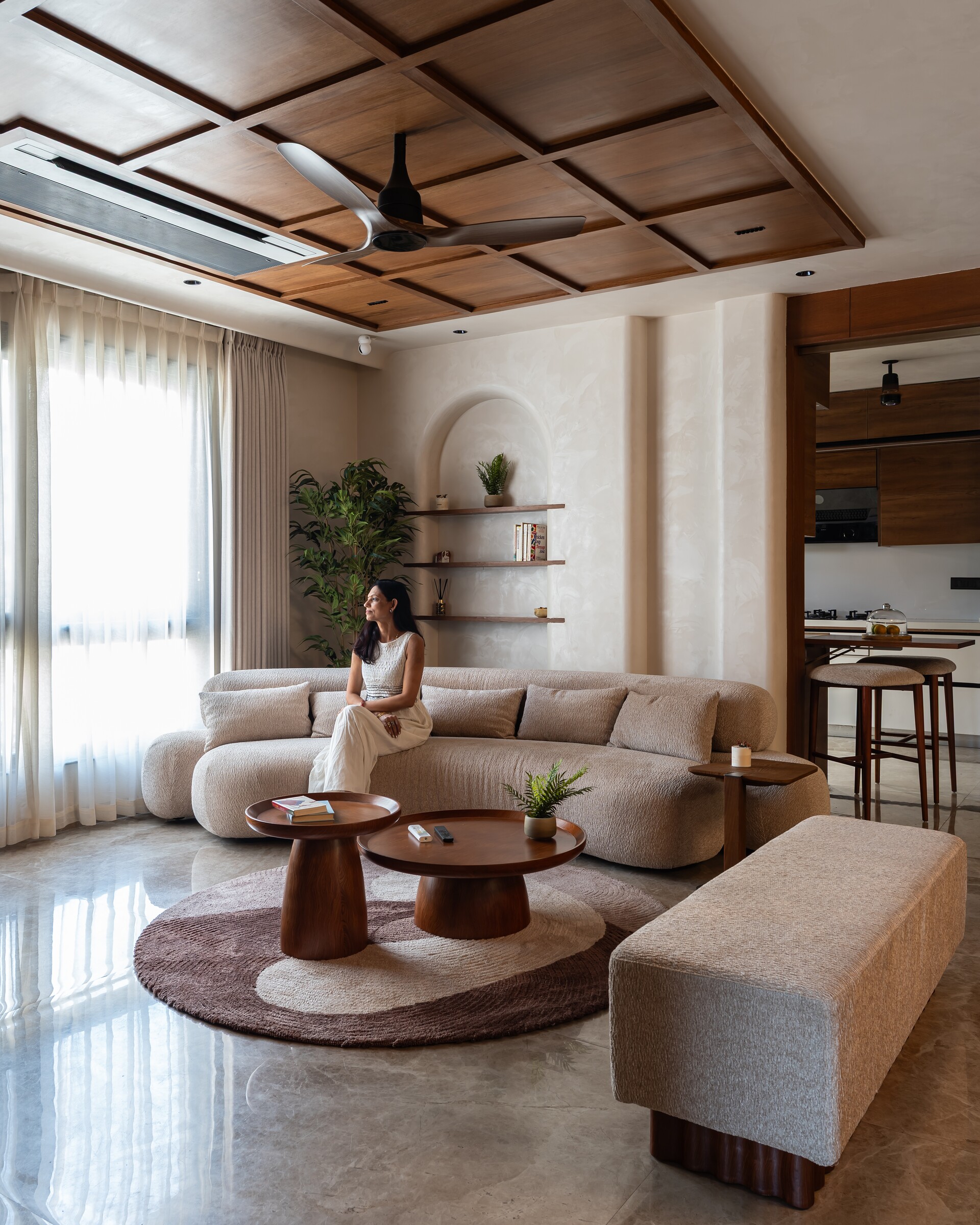 A light-filled living room, curtains drawn back.
